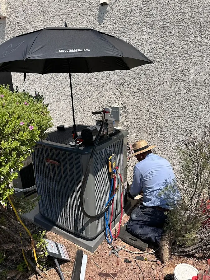 HVAC technician performing outdoor AC maintenance in Prescott